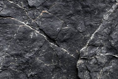 Koyu gri, siyah taş arka plan. Kaya dokusu. Siyah sayfa arkaplanı