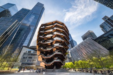 New York, NY - USA - April 14, 2023 Horizontal view of people enjoying the Vessel, a permanent art installation in the center of public plaza at the Hudson Yards complex, in Manhattan, New York City. clipart