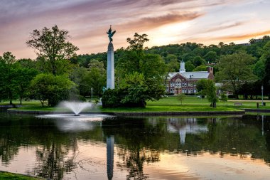 Montclair, NJ - USA - May 13, 2023  Sunset view of Soldiers and Sailors Memorial in Edgemont Park featuring the tall granite obelisk Winged Victory. Designed by sculptor Charles Keck in 1925. clipart
