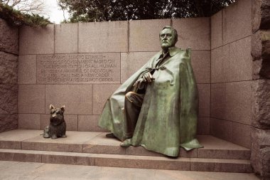 Washington DC - US - Mar 22, 2024 A sculpture of FDR sitting in a wheelchair with Fala, his Scottish Terrier, a part of the Franklin Delano Roosevelt Memorial, located on the Tidal Basi clipart