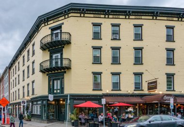 Kingston, NY - US - May 11, 2024 The yellow four story brick building on the corner of Broadway and West Strand Street is located in the heart of Kingston's Historic Rondout District