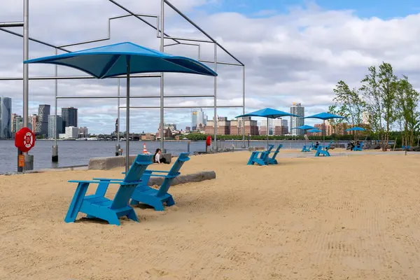 Stock image New York, NY - US - May 19, 2024 Closeup view of beach chairs and umbrellas at the new Gansevoort Peninsula; Manhattans first public beach with that overlooks the Hudson River