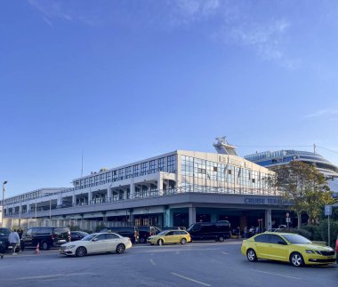 Piraeus, Attica - GR - Oct 25, 2024 The terminal at Piraeus, Greece, is a modern multi-story building with large glass windows, spacious vehicle access, and organized facilities for cruise travelers clipart