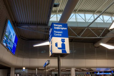 Attiki Odos, Spata - GR - Oct 27, 2024 Travelers walk through Athens International Airport under sleek, modern architecture. Screens display flights, while passport control keeps lines moving. clipart