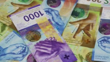 Swiss Francs  rotating on the table