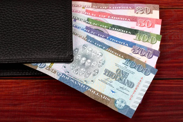 stock image Liberian money - dollar - new series of banknotes in the black wallet