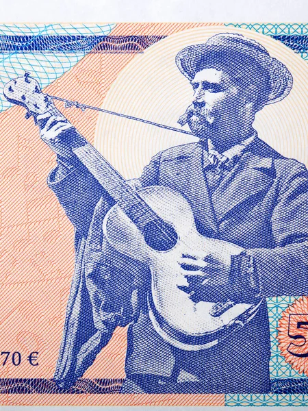 Man playing the guitar a portrait from money