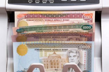 Turkmenistani money - manat in the counting machine clipart