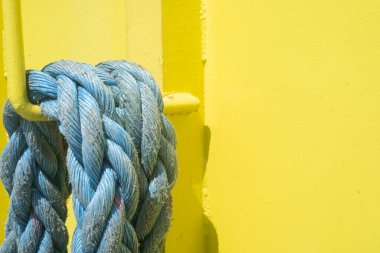 Details of the mooring top on the transport ship in Mexico, transportation and industry concept. Yellow background