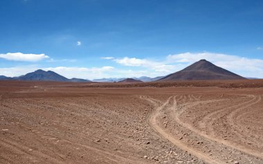 Empty tack crossing the wonderous landscapes, skies and mountains of the Altiplano in the high Andes of southwestern Bolivia