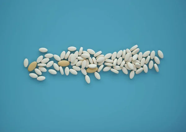 Handful of spread pills on a cyan background. Top view, copy space.