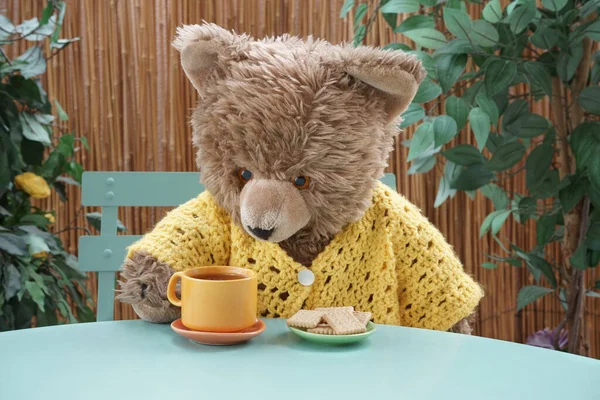 Ursinho Peluche Tomando Chá Biscoitos Sentados Uma Mesa Copo Laranja — Fotografia de Stock