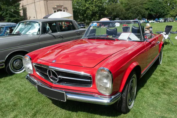 Stock image Mercedes-Benz 230 SL Pagoda convertible from 1964 exposed during the 47. International Oldtimer-Meeting 2024 in Baden-Baden, Germany. Part of the Trinkhalle building in the background.