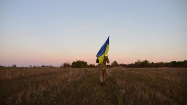 Militare Giovane Uniforme Che Jogging Con Bandiera Ucraina Prato Crepuscolo — Video Stock