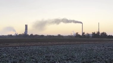 Termik santralin bacasından ağır gri duman dökülüyor. Sanayi fabrikasından atmosfere yayılan karbondioksit. Çevre kirliliği sorunu kavramı.