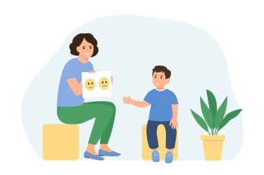 Çocuk psikoloğu çocuğa fotoğrafları gösteriyor. Zihinsel sorunları olan çocuklar için aile psikoterapisi seansı.