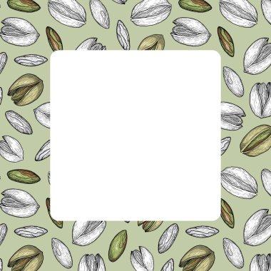 El yapımı şam fıstığı çerçevesi, yeşil arka plan ve beyaz ortadaki siyah ve beyaz fındık karışımı.