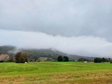 gray clouds on Pohorje Mountains. Slovenia. Autumn season. Overcast weather clipart