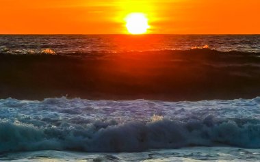 Sahilde sarı turuncu ve altın sarısı günbatımı ve Zicatela Puerto Escondido Oaxaca 'da tropikal doğada büyük dalga manzarası..