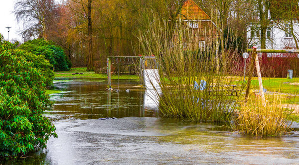 Frozen river stream pond and lake in cold nature forest environment in Langen Geestland Cuxhaven Lower Saxony Germany.