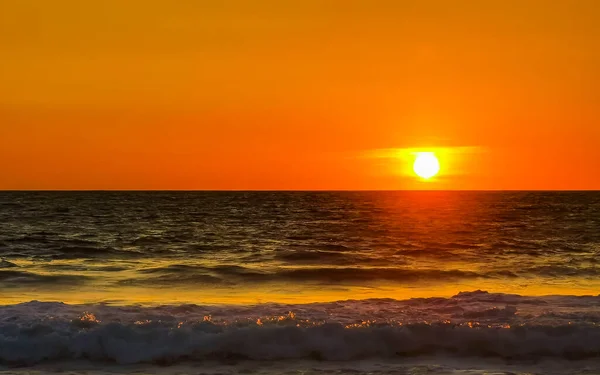 stock image Beautiful stunning colorful and golden sunset in yellow orange red on beach and big wave panorama in tropical nature in Zicatela Puerto Escondido Oaxaca Mexico.