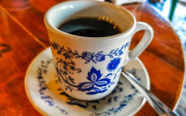 Zicatela Puerto Escondido Oaxaca Meksika 'daki El Cafecito' daki ahşap masada siyah kahve fincanı..