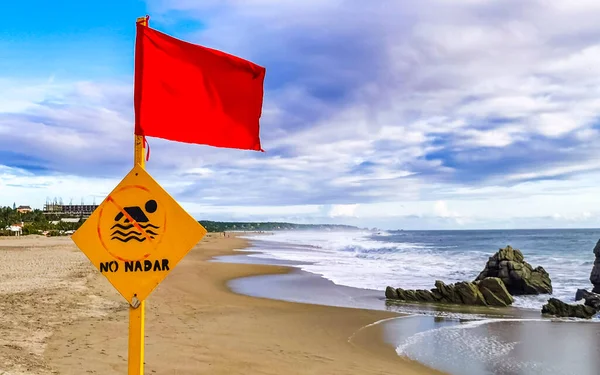 stock image Red flag swimming prohibited high waves in Zicatela Puerto Escondido Mexico.