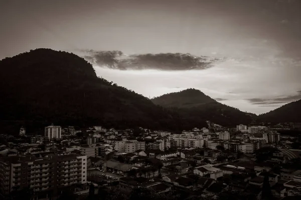 Old black and white picture of Beautiful colorful sunrise over the mountains of Angra dos Reis in Brazil.