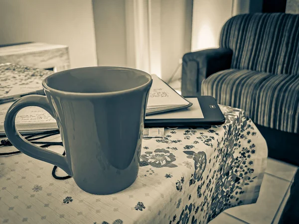 Old black and white picture of Red cup of coffee on grandmas table. Angra dos Reis Brazil.