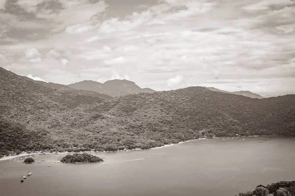 Old black and white picture of The big tropical island Ilha Grande Abraao beach panorama drone from above Angra dos Reis Rio de Janeiro Brazil.