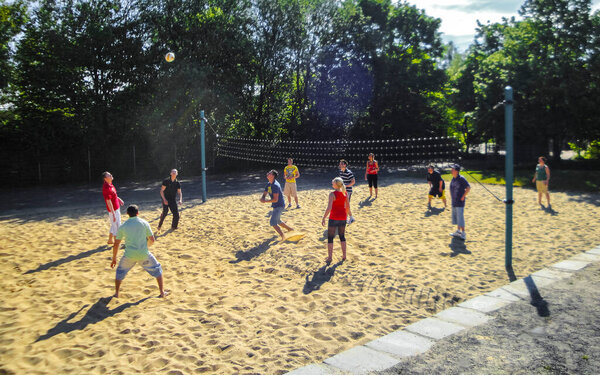 Leherheide Bremerhaven Germany 05. June 2010 Teenagers play volleyball outside with net and volleyball court in Leherheide Bremerhaven Bremen Germany.