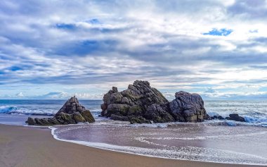 Zicatela Puerto Escondido Oaxaca 'daki plajda inanılmaz güzel büyük sörfçü dalgaları ve kayalar..