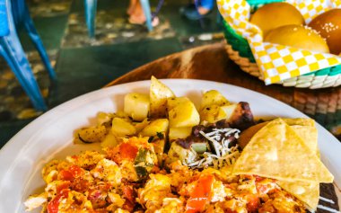 Meksika omleti ve siyah fasulyeli yumurta patates ve beyaz tabakta nachos Zicatela Puerto Oaxaca Meksika 'da El Cafecito' da..