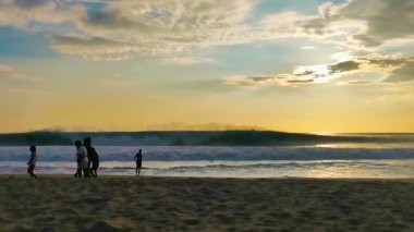 Puerto Escondido Oaxaca Mexico 04. October 2022 Beautiful stunning colorful and golden sunset in yellow orange red on beach and big wave panorama in Zicatela Puerto Escondido Oaxaca Mexico.