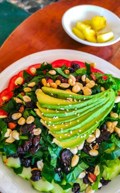 Healthy and beautiful salad with avocado spinach cucumber tomatoes and peanuts in Zicatela Puerto Escondido Oaxaca Mexico.
