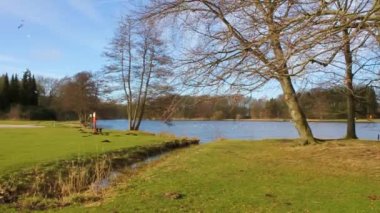 Natural beautiful panorama view with lake river fountain walking pathway and green plants trees in the forest of Speckenbtteler Park in Lehe Bremerhaven Germany.