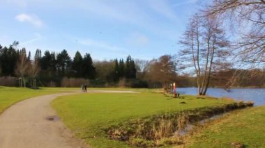 Natural beautiful panorama view with lake river fountain walking pathway and green plants trees in the forest of Speckenbtteler Park in Lehe Bremerhaven Germany.