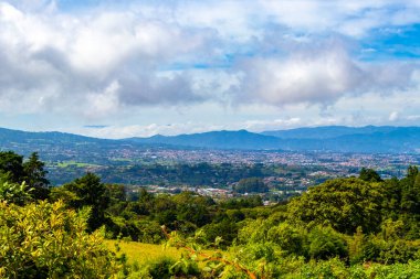 Beautiful mountain landscape and city panorama with forest trees clouds and nature of San Jose and Heredia in Costa Rica.