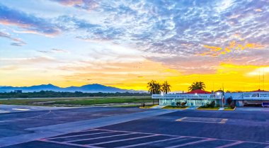 Colorful sunrise at airport with mountains in Zicatela Puerto Escondido Oaxaca Mexico. clipart