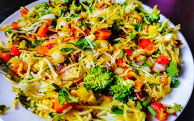 Vegetable dish soup with beans greens rice noodles onions tomato and garlic on a white plate bowl with fork or spoon in Mexico.