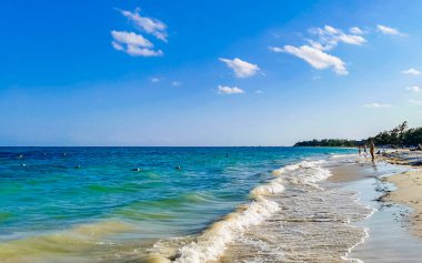 Tropical caribbean beach landscape panorama with clear turquoise blue water in Playa del Carmen Mexico.