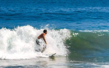 Surfer surfing on surfboard on high waves in Zicatela Puerto Escondido Oaxaca Mexico.