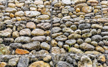 Stones rocks pinned behind a net in Zicatela Puerto Escondido Oaxaca Mexico.