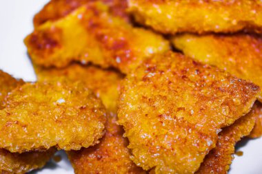 Crispy texture of chicken nuggets in plate pan in Leherheide Bremerhaven Bremen Germany.