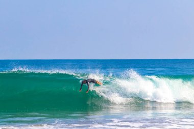 Surfer surfing on surfboard on high waves in Zicatela Puerto Escondido Oaxaca Mexico.