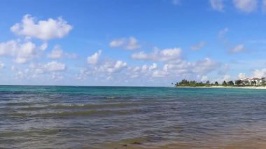 Tropical caribbean beach landscape panorama with clear turquoise blue water in Playa del Carmen Mexico.