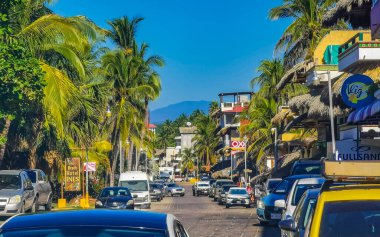 Puerto Escondido Oaxaca Mexico 2022 Beautiful scenic view panorama of the city and tourist street road with buildings hotels palm trees people and shops stores Puerto Escondido and Zicatela Oaxaca Mexico.