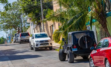 Playa del Carmen Quintana Roo Mexico 2021 Typical street road and cityscape with cars traffic restaurants shops stores people and buildings of Playa del Carmen in Quintana Roo Mexico.