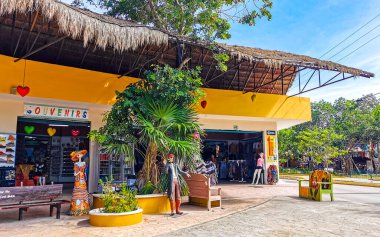 Tulum Mexico 23. July 2022 Typical colorful street road and cityscape with cars traffic palm tourism shops bars and restaurants of Tulum in Mexico.
