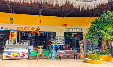 Tulum Mexico 23. July 2022 Typical colorful street road and cityscape with cars traffic palm tourism shops bars and restaurants of Tulum in Mexico.